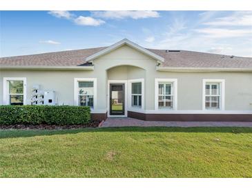 Charming home featuring a neatly landscaped lawn and a welcoming front entrance with lovely architectural detail at 3525 Belland Cir # A, Clermont, FL 34711