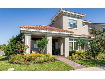 Charming home featuring a landscaped front yard, covered porch with swing, and a distinctive tile roof at 10231 Beechwood Ln, Orlando, FL 32832