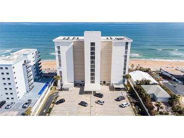 Exterior view of high-rise condo building near the beach with well-maintained parking and ocean views at 111 S Atlantic Ave # 301, Ormond Beach, FL 32176