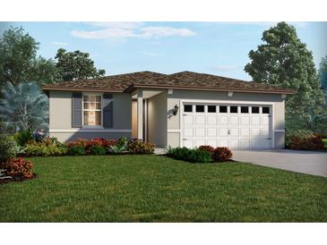 One-story home with a two-car garage and landscaped front yard at 325 Castle Dr, Lake Alfred, FL 33850