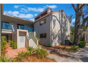 Building exterior with stairs, landscaping, and a walkway at 1000 Winderley Pl # 122, Maitland, FL 32751