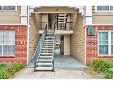 View of the condo exterior with stairs leading to the units at 13003 Plantation Park Cir # 1319, Orlando, FL 32821