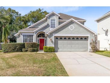 Two-story house with gray siding, red door, and attached garage at 1834 Duffy Ct, Lake Mary, FL 32746