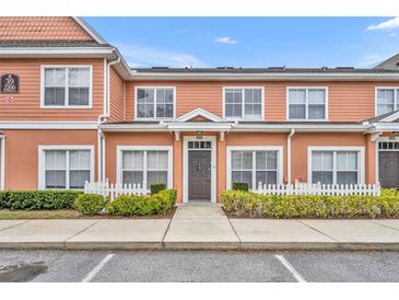 Charming townhouse featuring a welcoming entryway and manicured landscaping at 2200 San Vittorino Cir # 104, Kissimmee, FL 34741