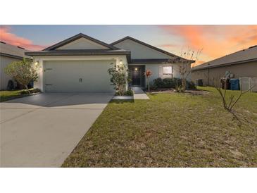 Charming single-story home with a well-manicured lawn and two car garage at 330 Pheasant Dr, Haines City, FL 33844