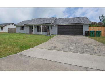 Charming single-story home featuring a two car garage, fresh landscaping, and a driveway with a basketball hoop at 1659 Nantucket St, Deltona, FL 32725