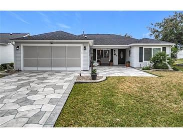 Charming single-story home featuring a two car garage, and patterned stone driveway at 2488 Cherokee Ct, The Villages, FL 32162