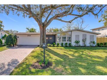 Charming single-story home with brick driveway, lush lawn, and mature shade tree at 2520 Chanute Trl, Maitland, FL 32751