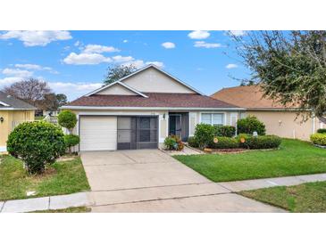 Charming single-story home featuring well-maintained landscaping, a two-car garage, and a welcoming entryway at 2556 Brookstone Dr, Kissimmee, FL 34744