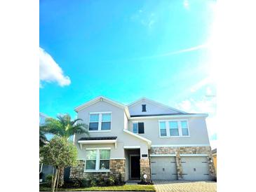 Charming two-story home with a two-car garage and stone accents at 4612 Terry Town Dr, Kissimmee, FL 34746