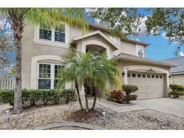 Beautiful two-story home featuring a well-manicured yard and attached two-car garage at 4941 Casa Vista Dr, Orlando, FL 32837