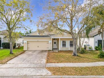 Charming single-story home with mature trees, attached garage, and neutral exterior paint at 4981 Waterside Pointe Cir, Orlando, FL 32829