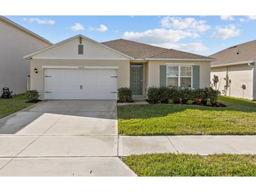 Charming single-story home with a well-maintained lawn, two-car garage, and neutral color scheme at 5654 Winona Dr, St Cloud, FL 34771