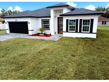 Charming single Gathering home featuring a front yard, an attached garage and modern architectural design at 15657 Sw 37Th Cir, Ocala, FL 34473