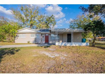 Charming single-story home featuring a quaint front porch and a well-manicured lawn at 1707 Gammon Ln, Orlando, FL 32811