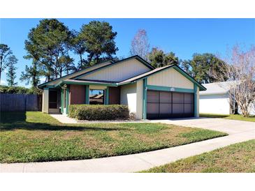 Charming single-story home with a well-maintained lawn, garage, and tidy landscaping at 3188 Owassa Ct, Kissimmee, FL 34746