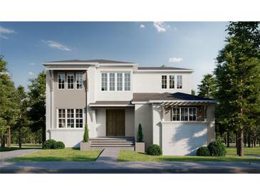 Stunning two-story home showcasing a modern design with a neutral color palette and manicured landscaping at 572 Sanctuary Golf Pl, Apopka, FL 32712