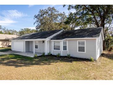 Charming single-story home with well-maintained lawn and attached one-car garage at 6356 Sleepy Hollow Dr, Orlando, FL 32810