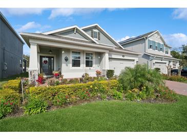 Charming single Gathering home with manicured landscaping and inviting front porch at 2606 Pinyonpine Ln, Sanford, FL 32773