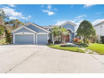 Charming single-story home with a three-car garage and a beautifully landscaped front yard, perfect for curb appeal at 2929 University Acres Dr, Orlando, FL 32817