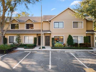 Charming townhouse featuring a well-maintained facade and ample parking in a desirable neighborhood at 311 Sandlewood Trl # 4, Winter Park, FL 32789