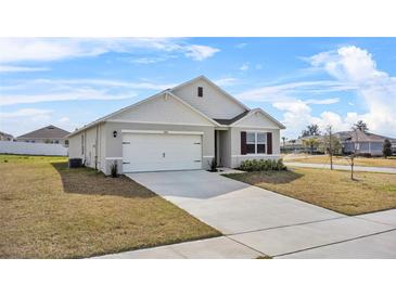 Charming single-Gathering home with a well-manicured lawn and a two-car garage at 3842 Rory Oak Circle, Apopka, FL 32703