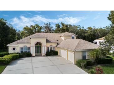 Charming single-story home featuring a spacious driveway, manicured landscaping and a 3-car garage at 126 Seville Chase Dr, Winter Springs, FL 32708