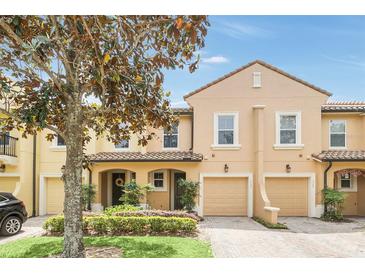 Charming two-story townhome featuring a tile roof, attached garage, and beautifully landscaped front yard at 1347 Benevolent St, Maitland, FL 32751