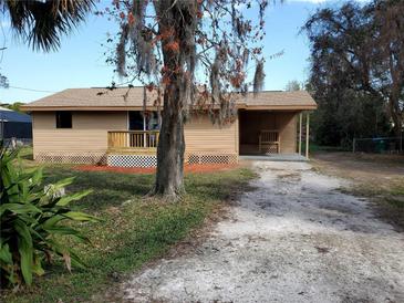 Charming single-story home featuring a quaint front porch and spacious gravel driveway at 1583 Montgomery Ave, Holly Hill, FL 32117