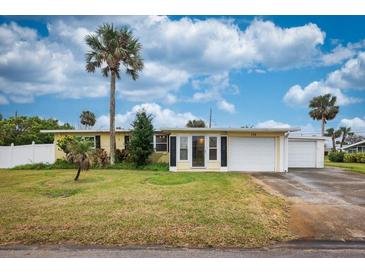 Charming single-story home with a well-maintained lawn and tropical landscaping at 198 Benjamin Dr, Ormond Beach, FL 32176