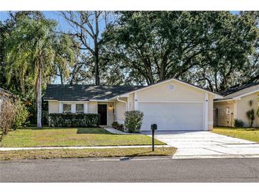 Charming one story home featuring lush landscaping, an attached two car garage, and a well maintained lawn at 2811 Curry Woods Dr, Orlando, FL 32822