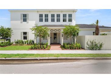 Charming two-story home with landscaped yard and a striking white exterior at 3011 Amherst Ave, Orlando, FL 32804