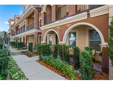 Charming townhome with beautiful landscaping, stucco, arched doorways, and balcony at 3321 Messina Dr, Lake Mary, FL 32746