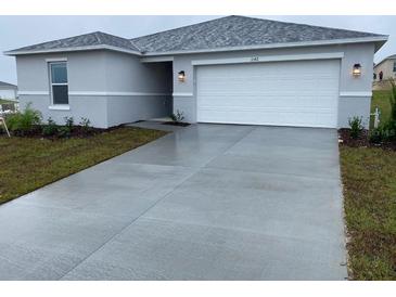 Charming one-story home featuring a two-car garage and well-manicured landscaping in a peaceful neighborhood at 3342 Pink Oleander, Mascotte, FL 34753