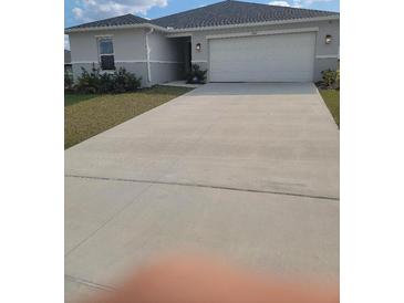 Charming one-story home with a two-car garage and a well-maintained front yard at 3342 Pink Oleander, Mascotte, FL 34753