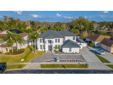 Stunning two-story home boasts manicured landscaping, a beautiful fountain, and a circular driveway at 352 Radisson Pl, Oviedo, FL 32765