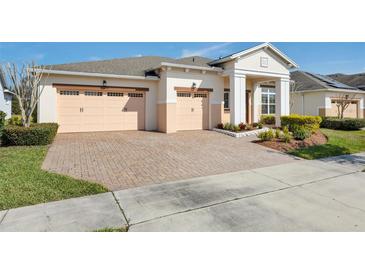 Charming single-story home with a three-car garage and a beautiful brick paver driveway at 4909 Drawdy Ct, St Cloud, FL 34772