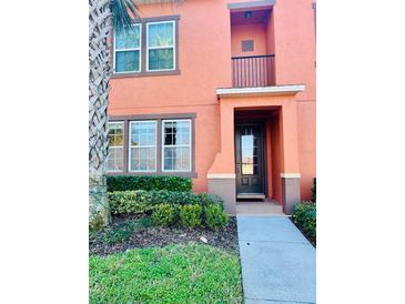 Charming two-story townhome with a small front balcony and well-maintained landscaping at 561 Telfair Square Ct, Sanford, FL 32771