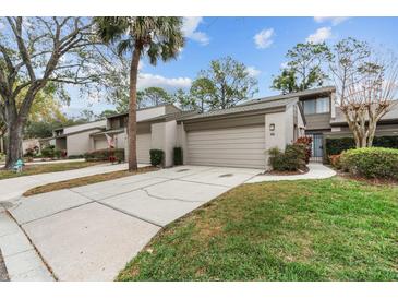 Charming townhome with attached garage, inviting walkway, and well-maintained landscaping at 95 Carolwood Blvd, Fern Park, FL 32730