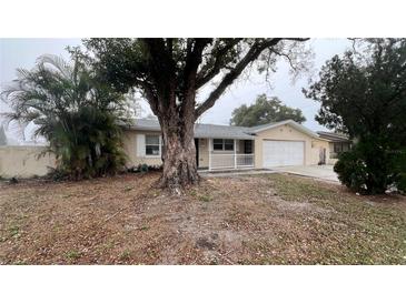 Charming single-story home with a well-manicured lawn and a welcoming front porch at 1201 S Oxalis Ave, Orlando, FL 32807