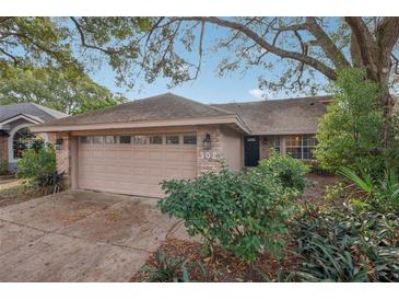 Charming home with well-maintained front yard and attached two-car garage at 302 Bridie Ct, Winter Springs, FL 32708