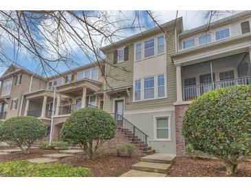 Charming townhome with a brick facade, covered porch, and well-maintained landscaping at 486 Windmill Palm Cir, Altamonte Springs, FL 32701