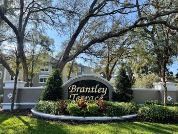 Attractive Brantley Terrace entrance sign with lush landscaping and mature trees creates a welcoming feel to the neighborhood at 583 Brantley Terrace Way # 303, Altamonte Springs, FL 32714