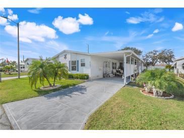 Charming single-story home with well-manicured lawn and patterned concrete driveway at 6302 Bayberry Ne Blvd, Winter Haven, FL 33881