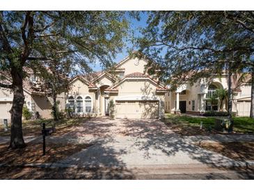 Charming home featuring a well-manicured lawn and a two-car garage at 6825 Dolce St, Orlando, FL 32819