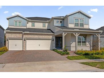 Beautiful two-story home with a three-car garage and stone accents at 8309 Park Cliff Way, Orlando, FL 32836