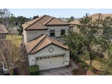 Charming two-story home featuring a two-car garage and a well-maintained tile roof at 1494 Moon Valley Dr, Davenport, FL 33896