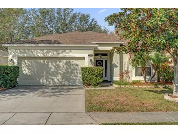 Charming single-story home with a well-maintained lawn and an attached two-car garage at 1843 Van Allen Loop, Auburndale, FL 33823