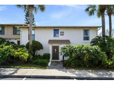 Inviting condo exterior with lush landscaping, palm trees, and a private entrance at 200 Maitland Ave # 96, Altamonte Springs, FL 32701