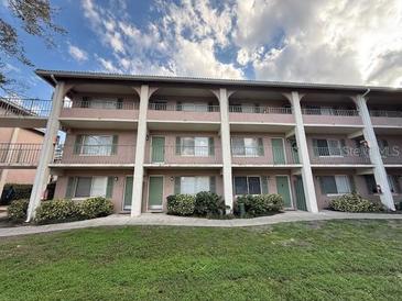 Spacious condo building showing lush lawn and manicured shrubbery at 125 Water Front Way # 200, Altamonte Springs, FL 32701